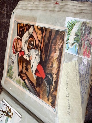 A "Mark Twain's Adhesive Scrap Book" given as a gift to Nettie (Annette Bush, Jackson, Michigan) from Emma M. Peake on May 17th, 1878 who has filled it with colorful advertising cards